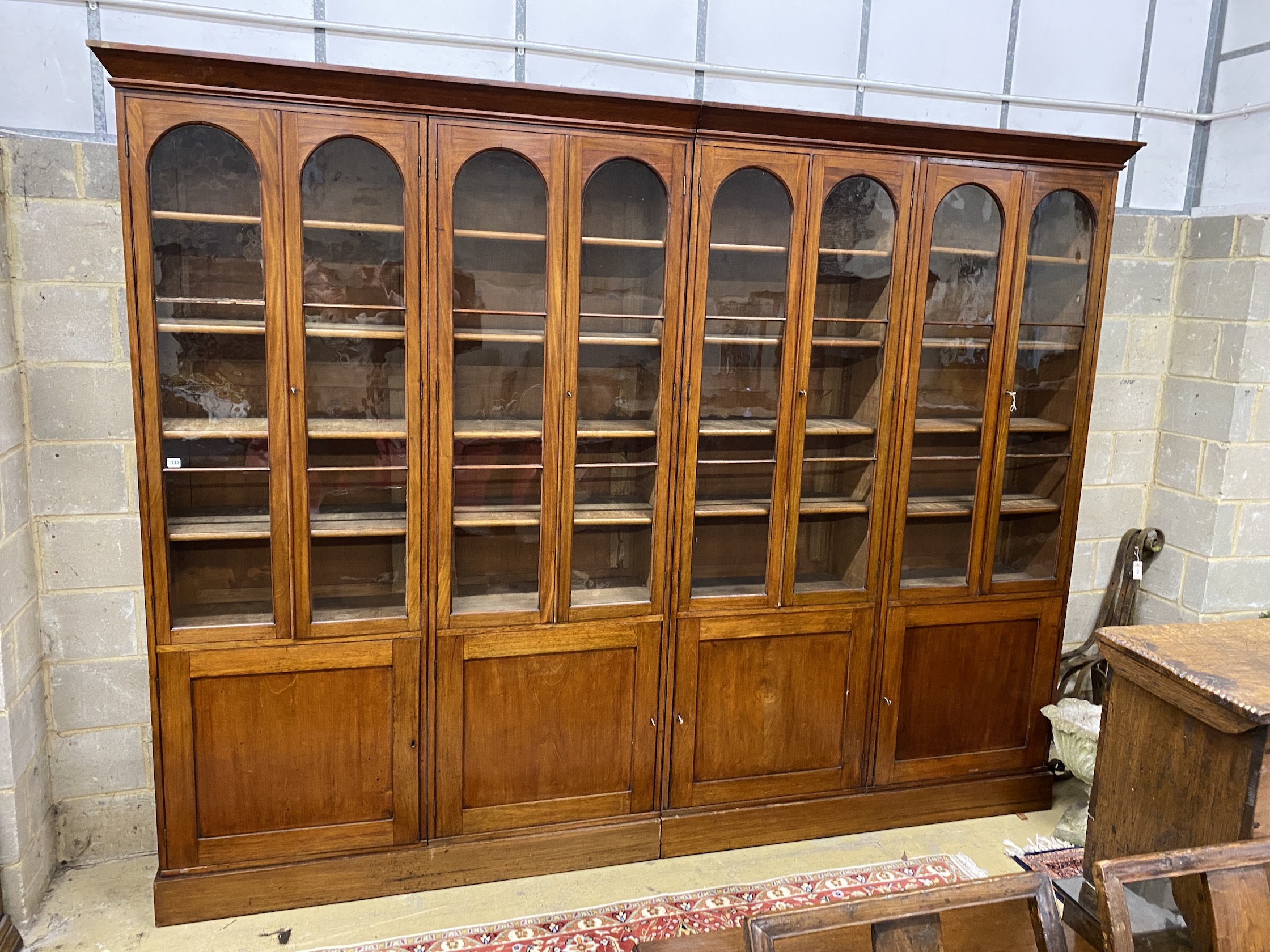 A Victorian glazed mahogany library bookcase, length 312cm, depth 42cm, height 240cm